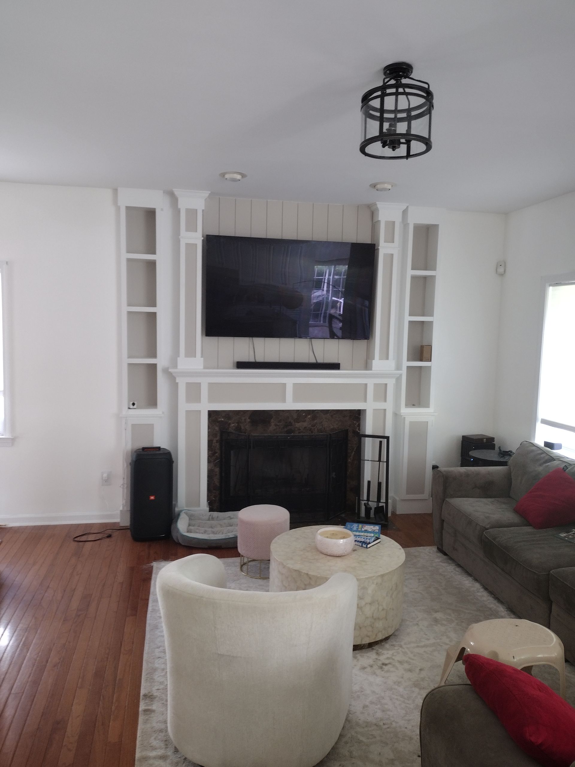 A living room with a fireplace and a flat screen tv
