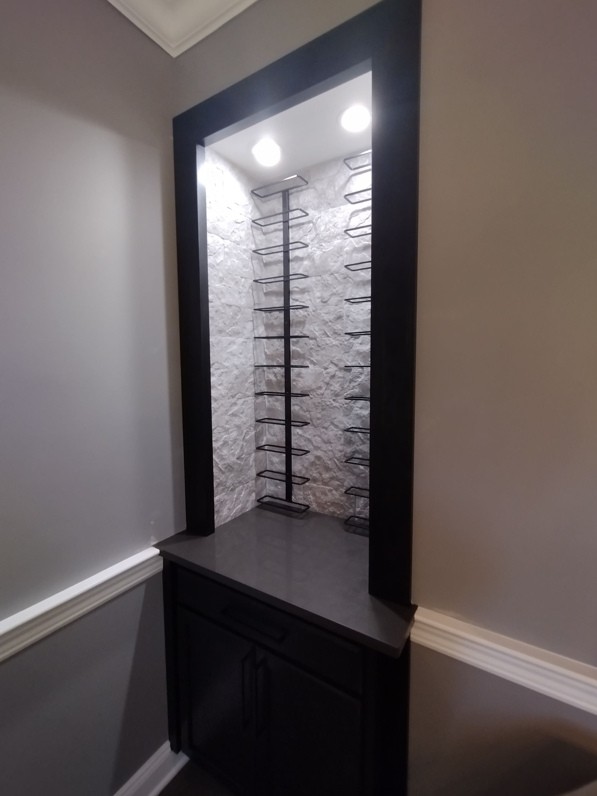 There is a wine rack in the corner of the room.