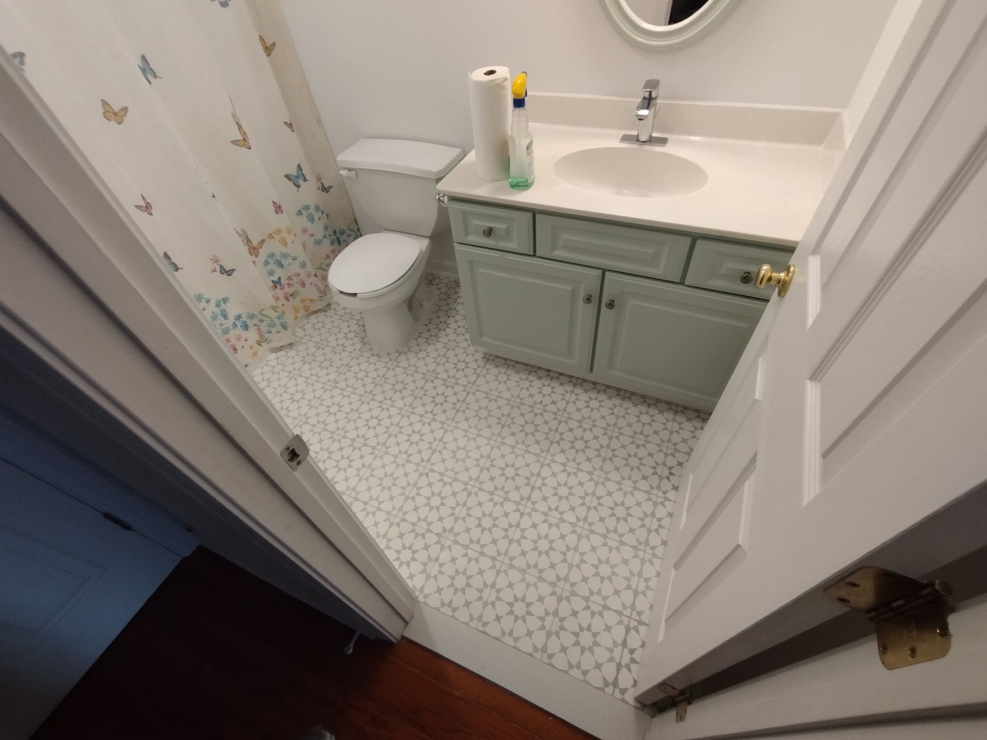 A bathroom with a toilet , sink , and shower curtain.