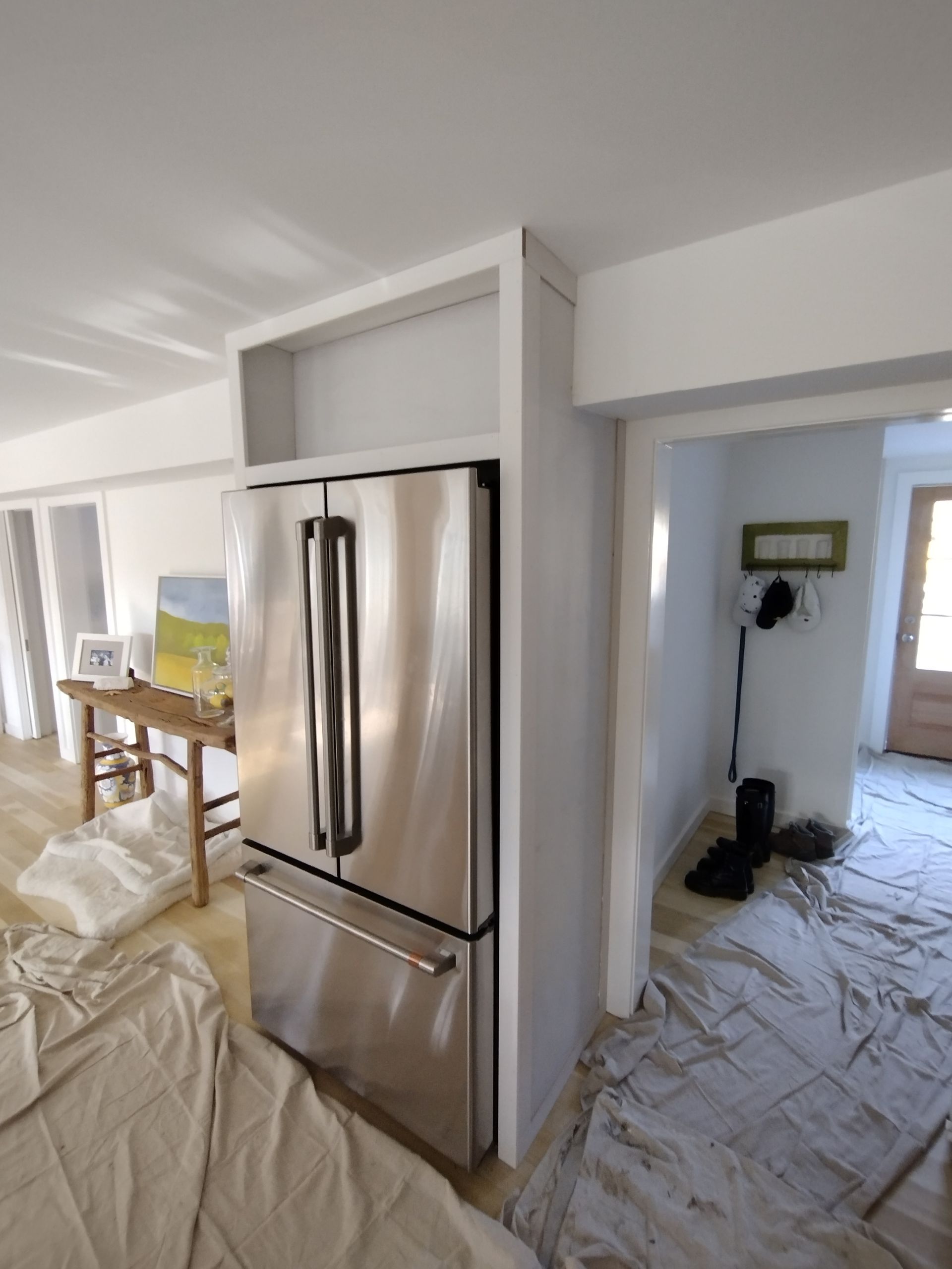 A stainless steel refrigerator is in a kitchen