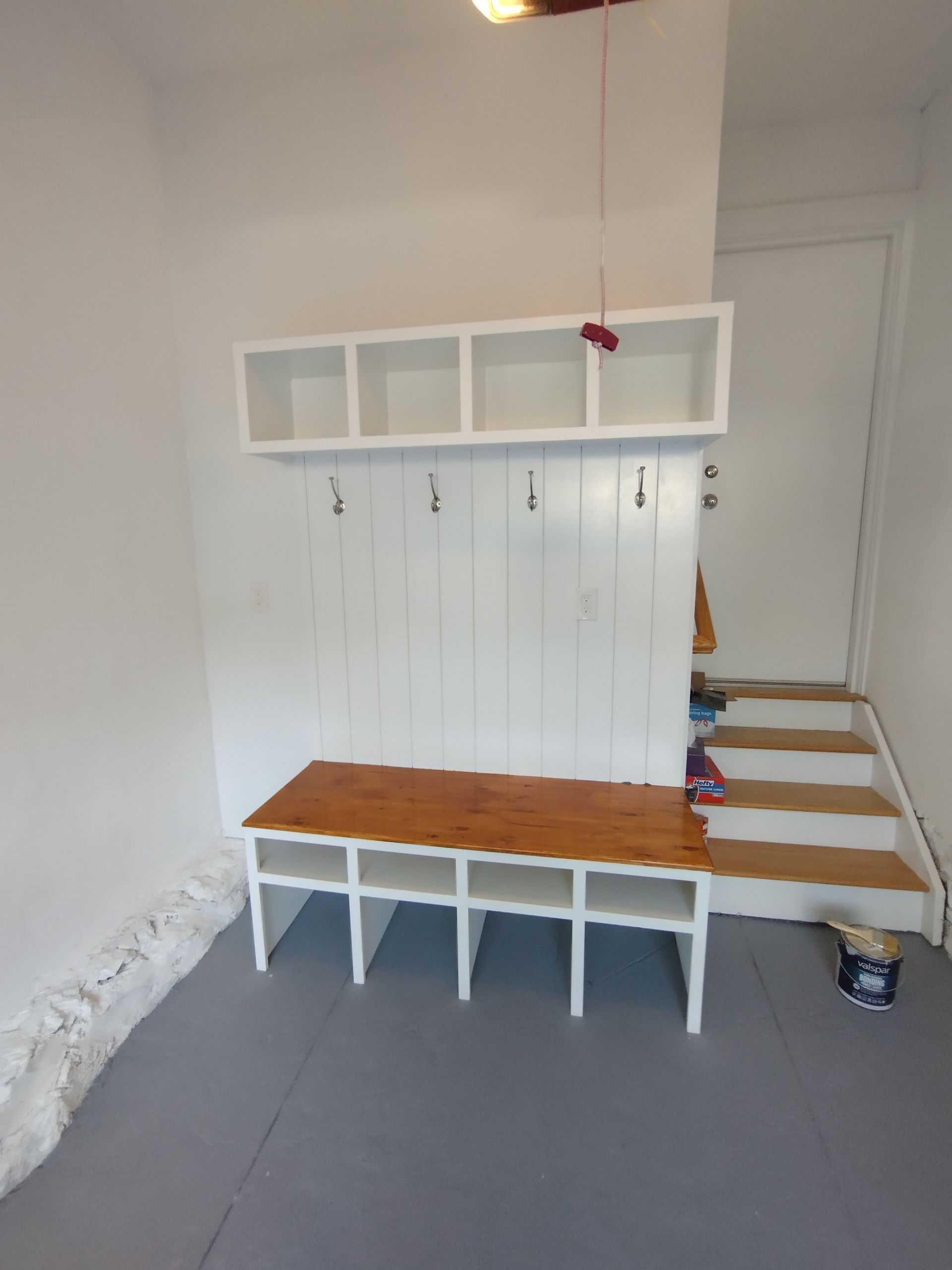 A room with a bench and stairs in it