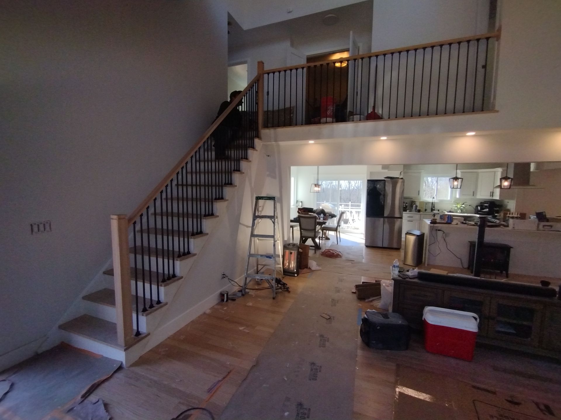 A living room with stairs leading up to the second floor