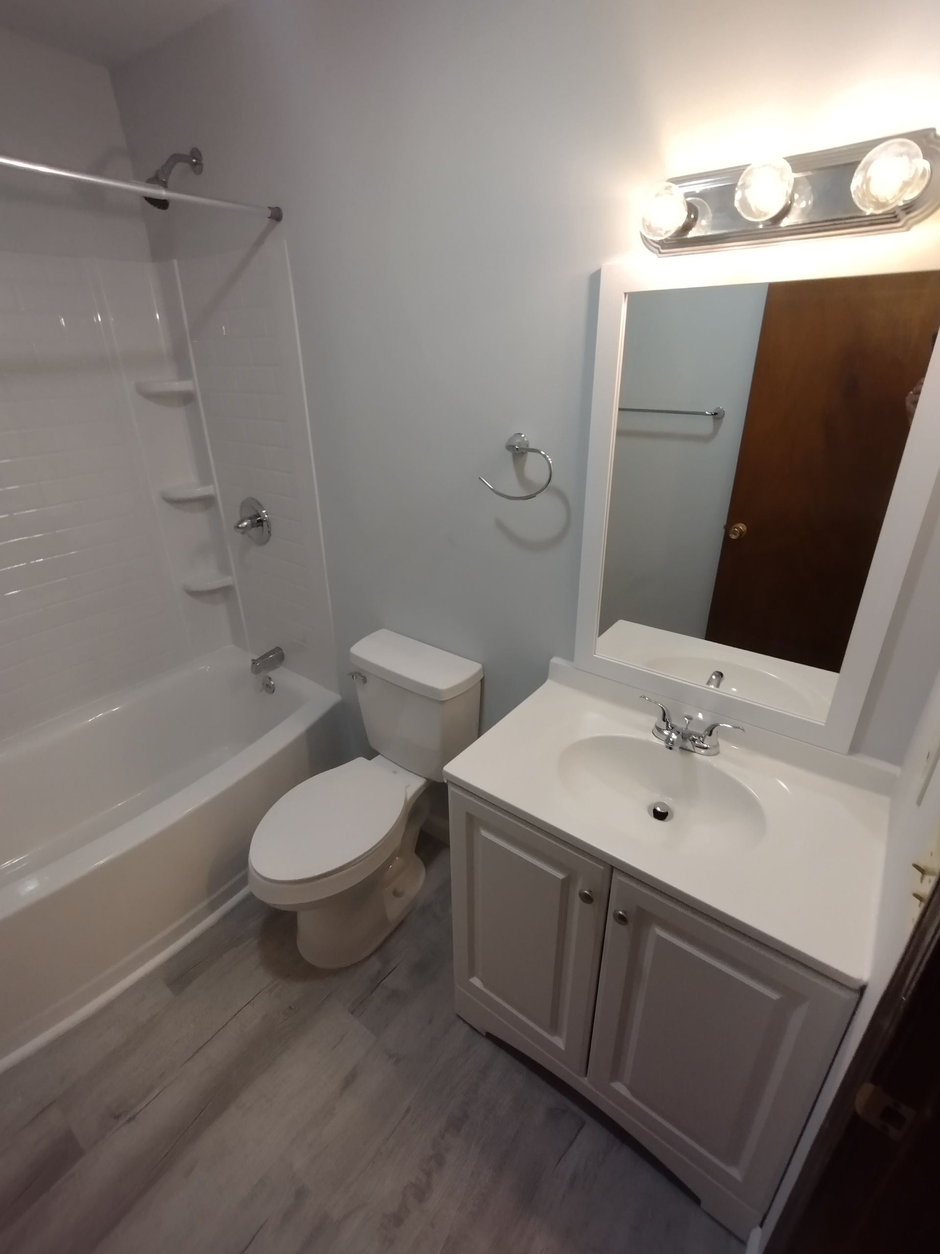 A bathroom with a toilet a sink and a bathtub