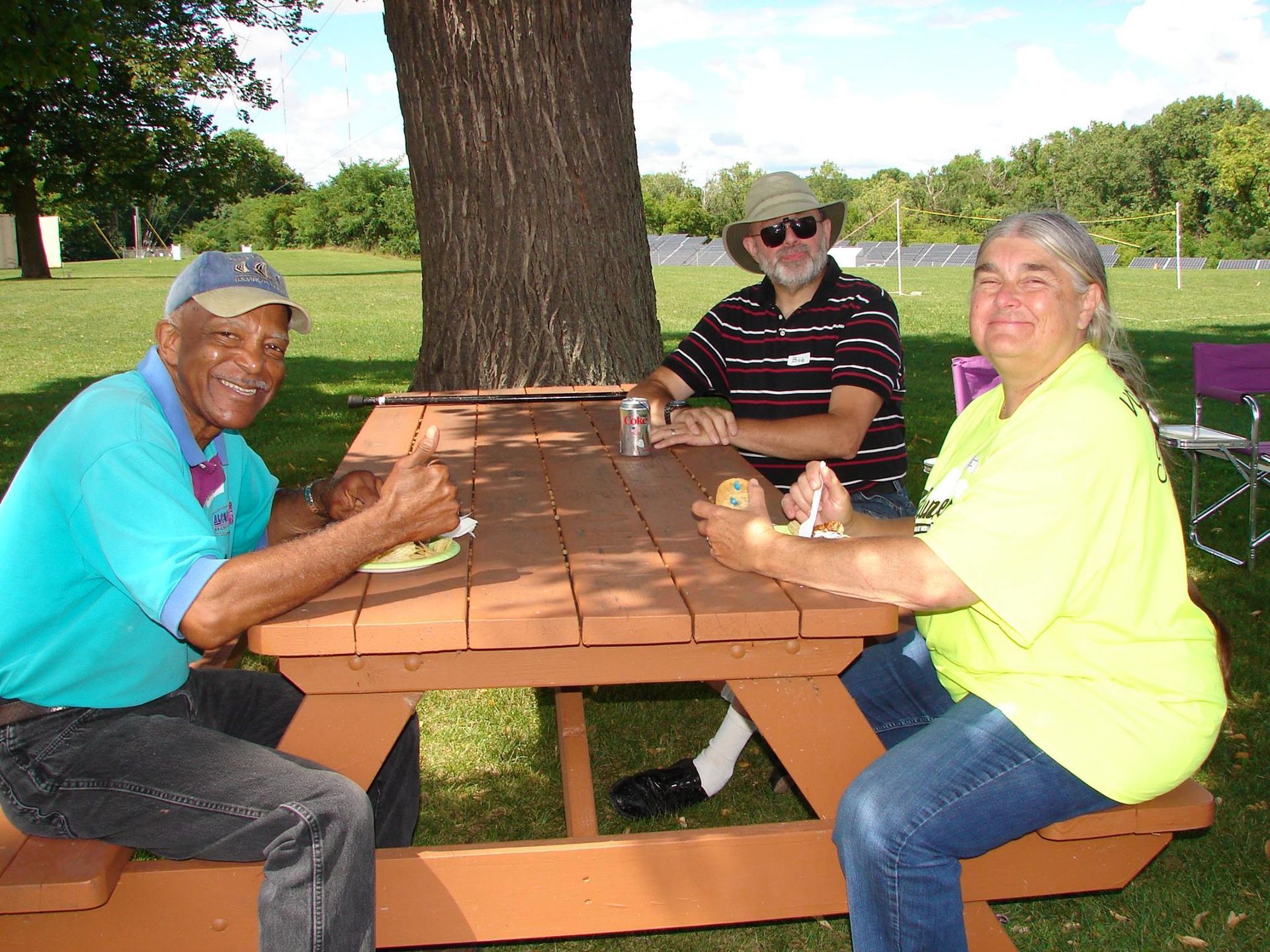 A group of people sitting at a picnic table