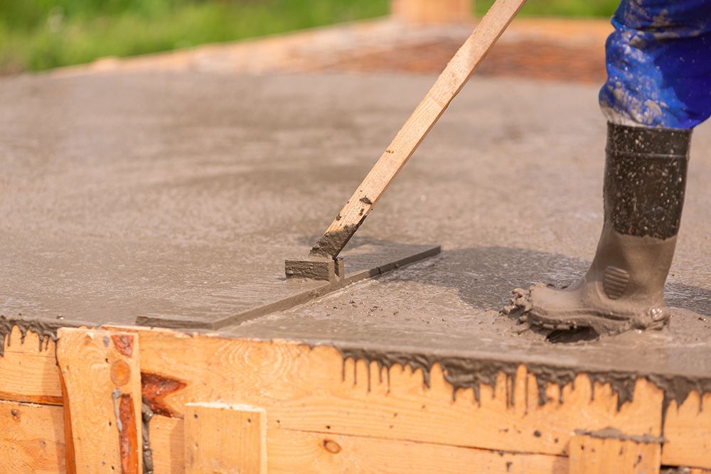 a person with a tool on top of a cement slab