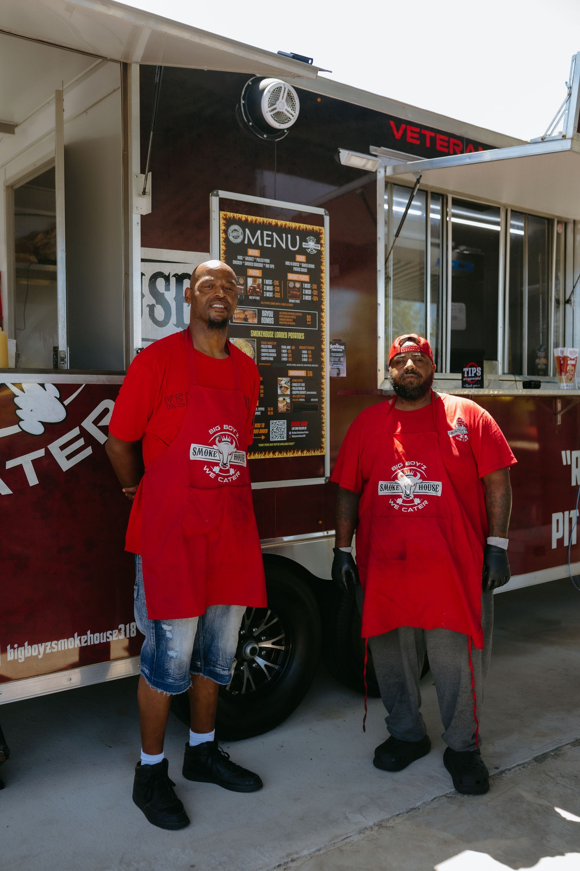 A pile of smoked chicken wings and legs in a container.