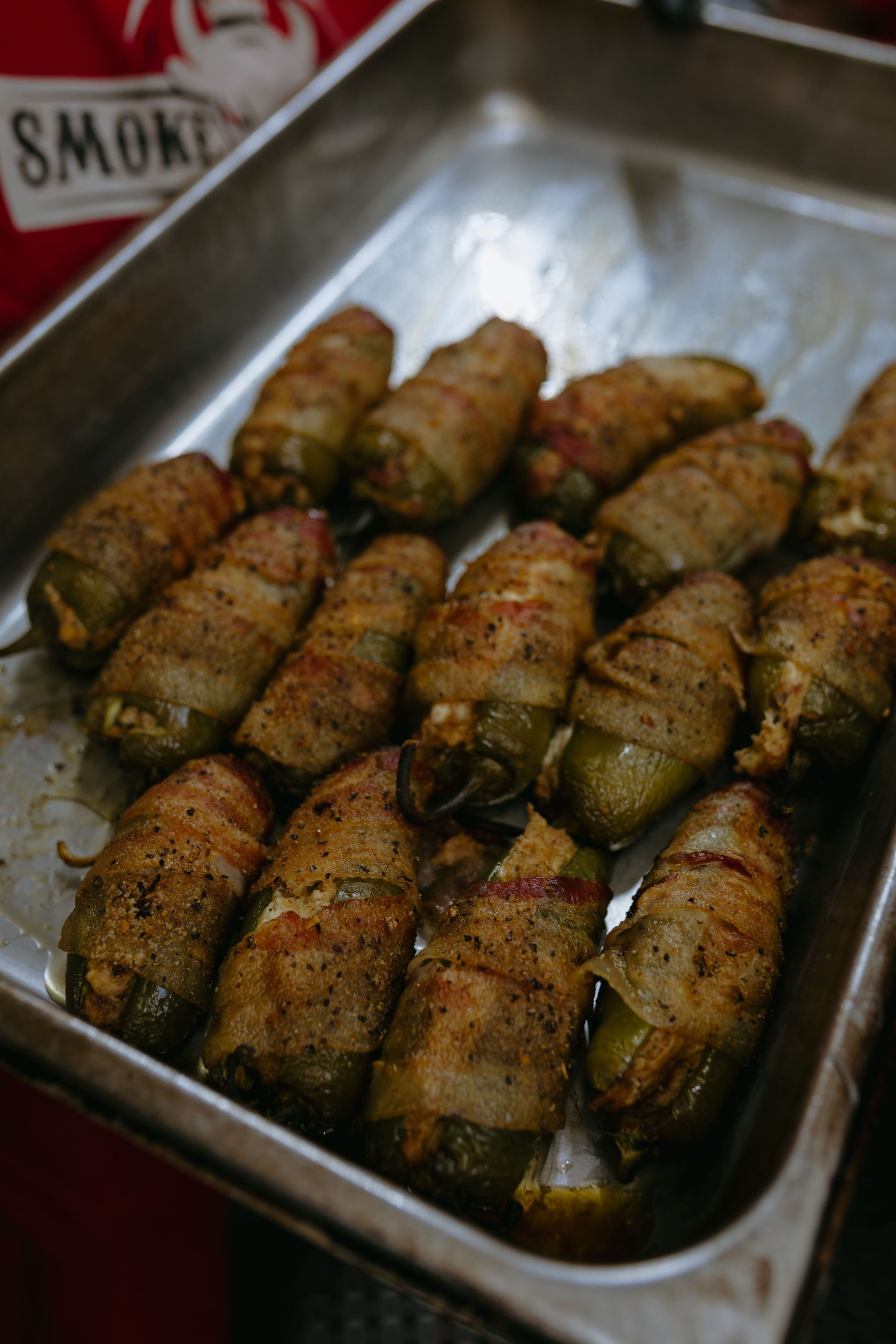 A tray of meat is sitting on a checkered paper.