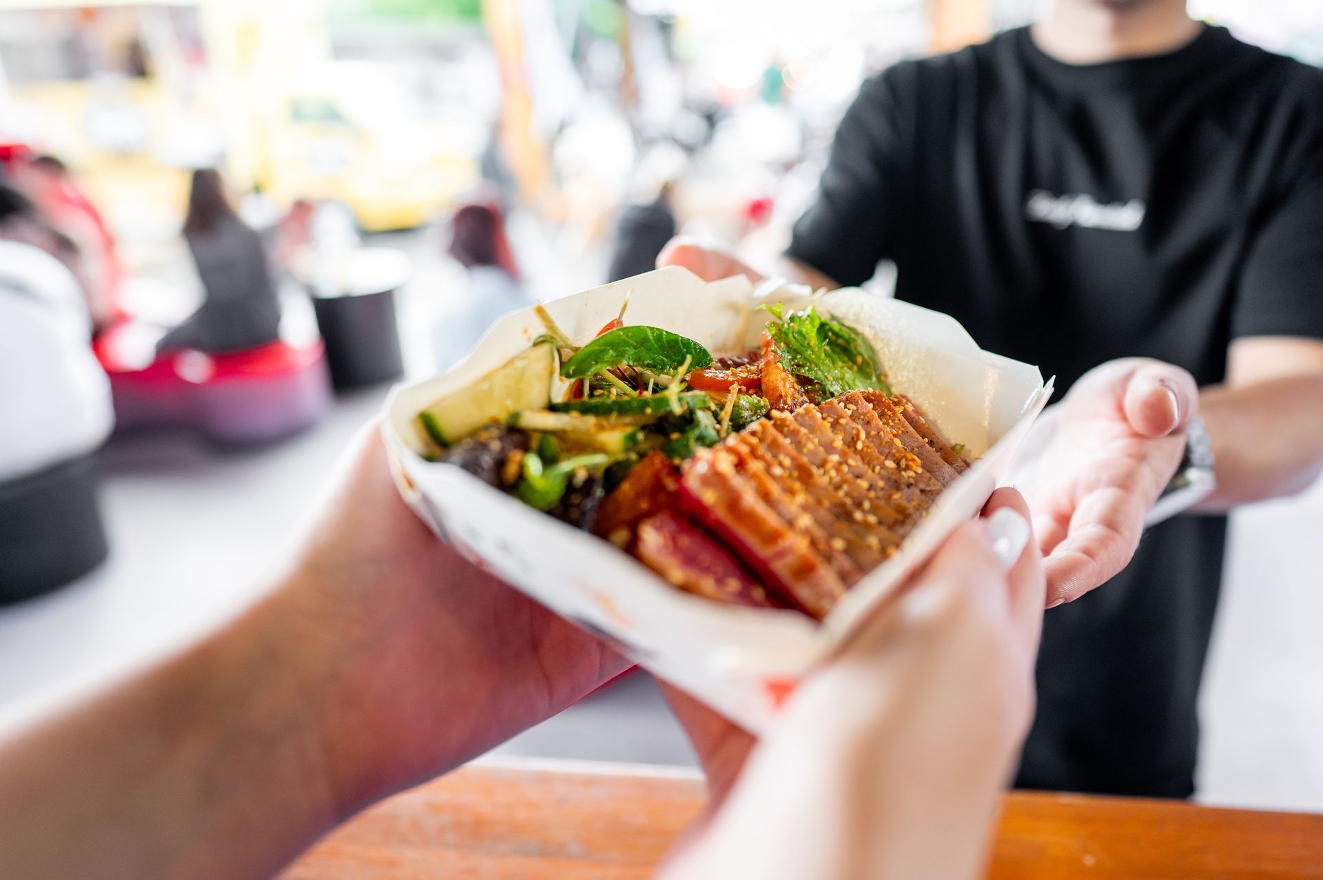 A person is holding a plate of food in their hands.