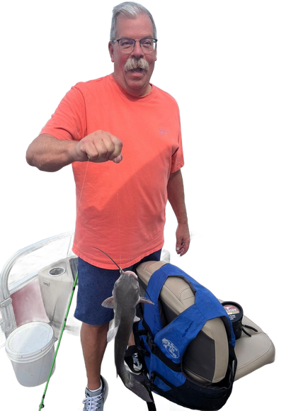 Man in orange shirt holds up fist, next to a fish and life vest.