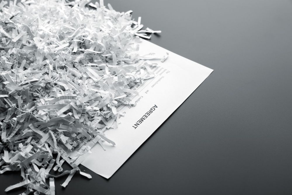 A pile of shredded paper is sitting on top of a piece of paper.