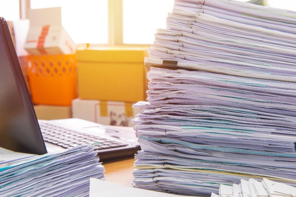 An agreement is sitting on top of a pile of shredded paper.