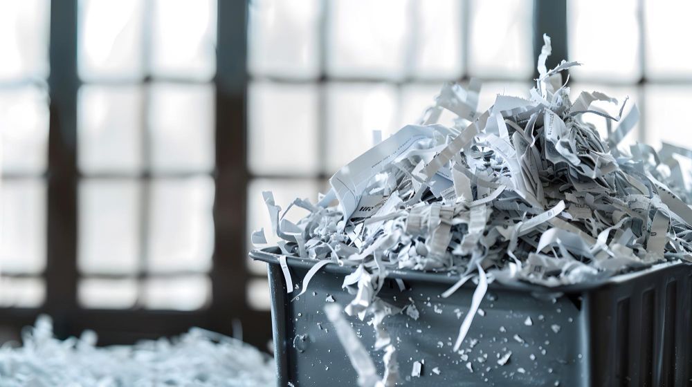 A pile of shredded paper in a trash can.