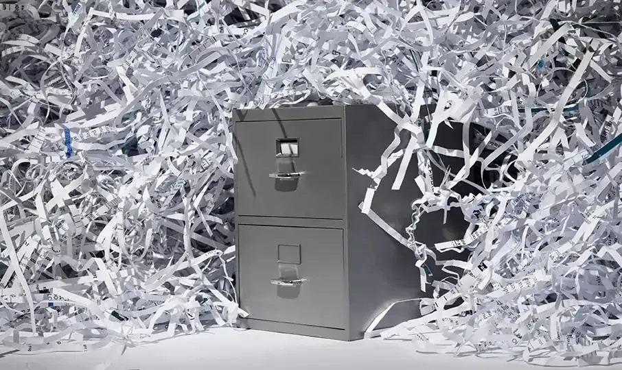 Metal filing cabinet with shredded paper, showing large-volume purge shredding in the Bay Area.