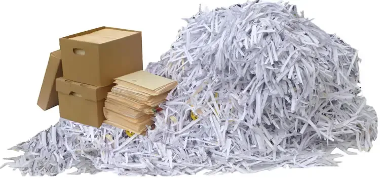Cardboard boxes and documents next to shredded paper, showing one-time shredding cost for bulk disposal.