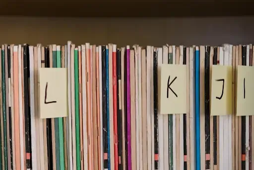 Labeled folders organized alphabetically with sticky notes marked 