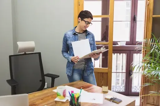 Person reviewing paperwork in a modern office, representing digital data destruction Santa Clara.


