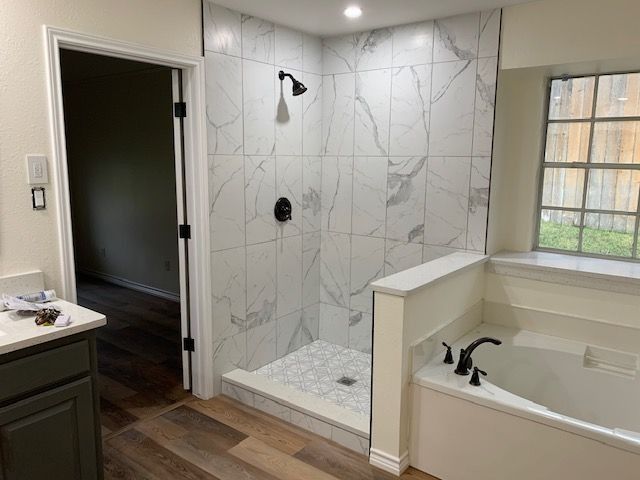Modern bathroom with white marble tile shower and bathtub