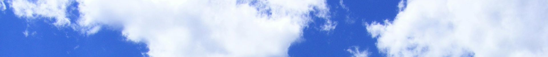 Blue sky with streaks of white, resembling clouds or a water reflection.