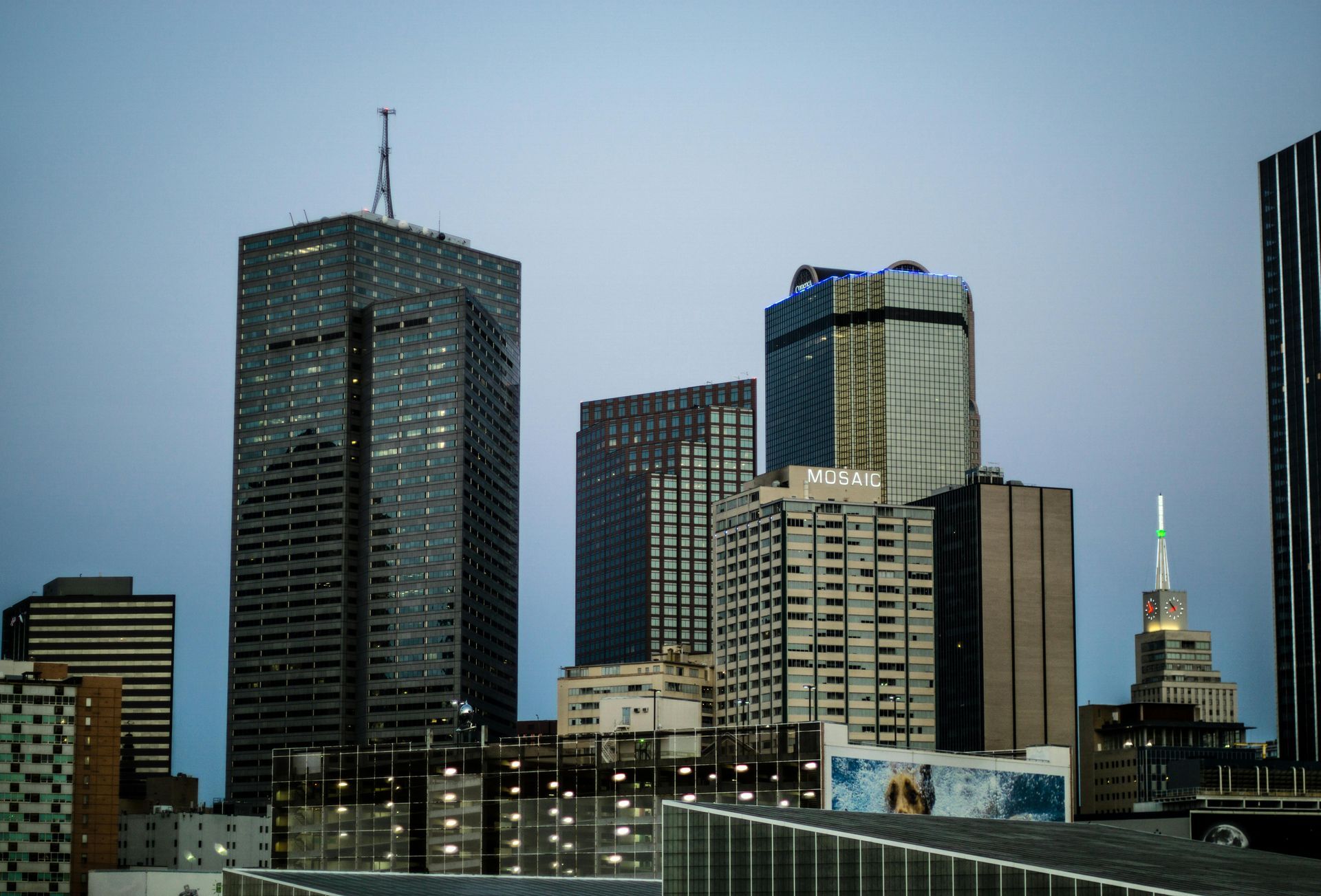 City skyline against a dusk sky, featuring various skyscrapers.