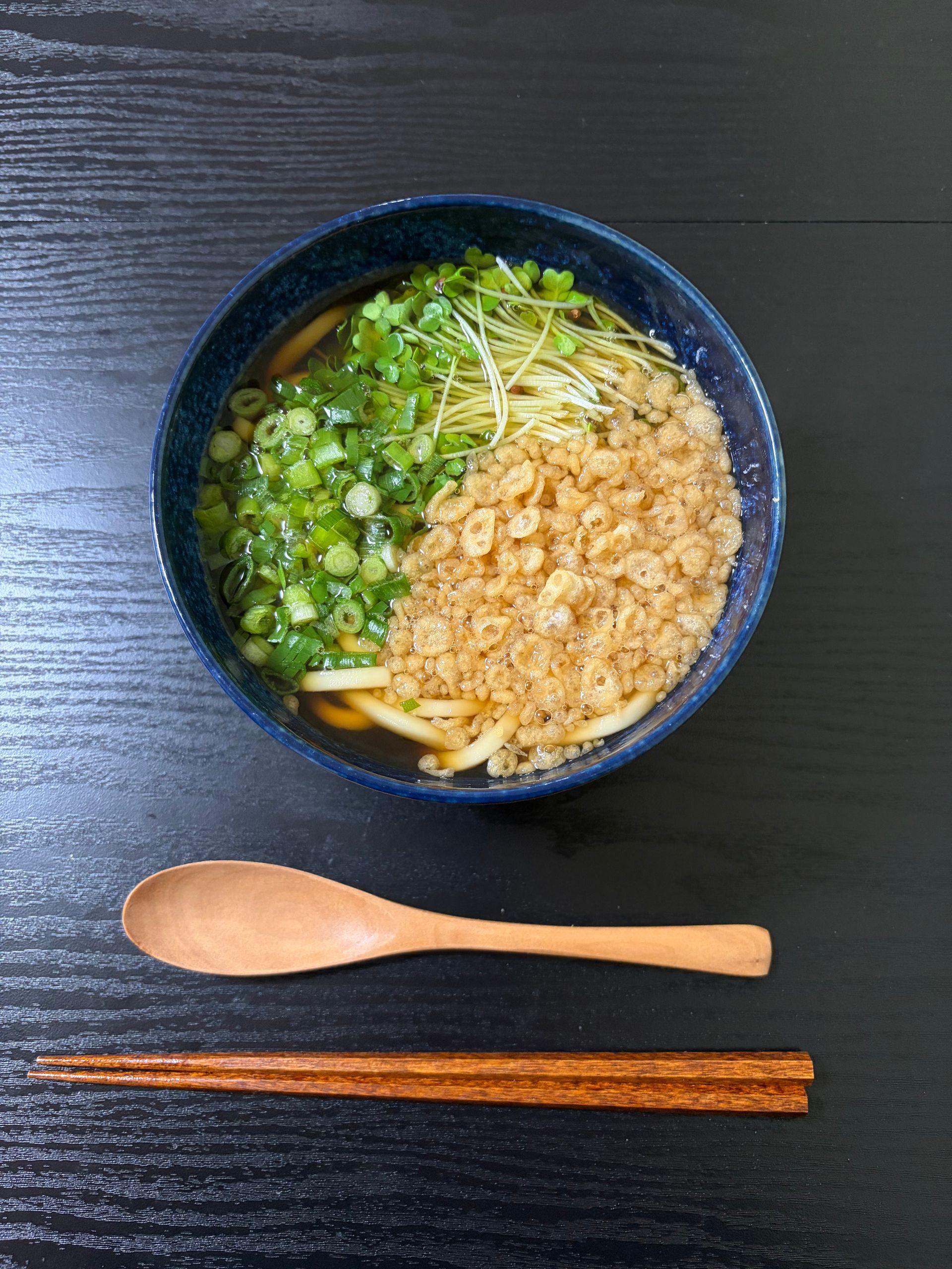 udon in soup with vegetables and tenkasu