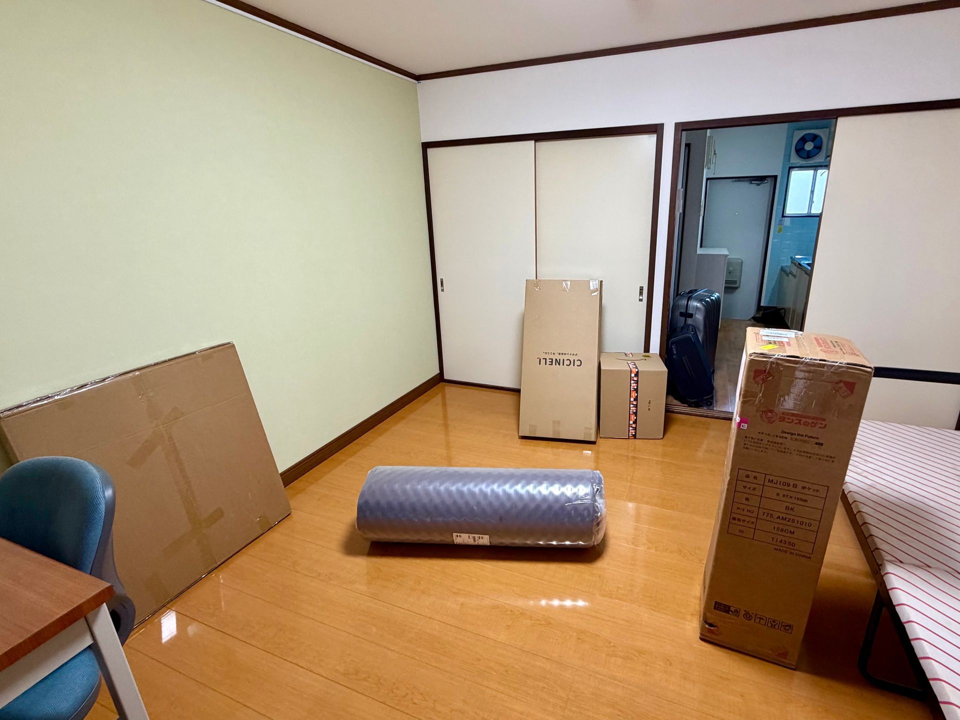 empty apartment before unpacking with carton boxes with mattres etc