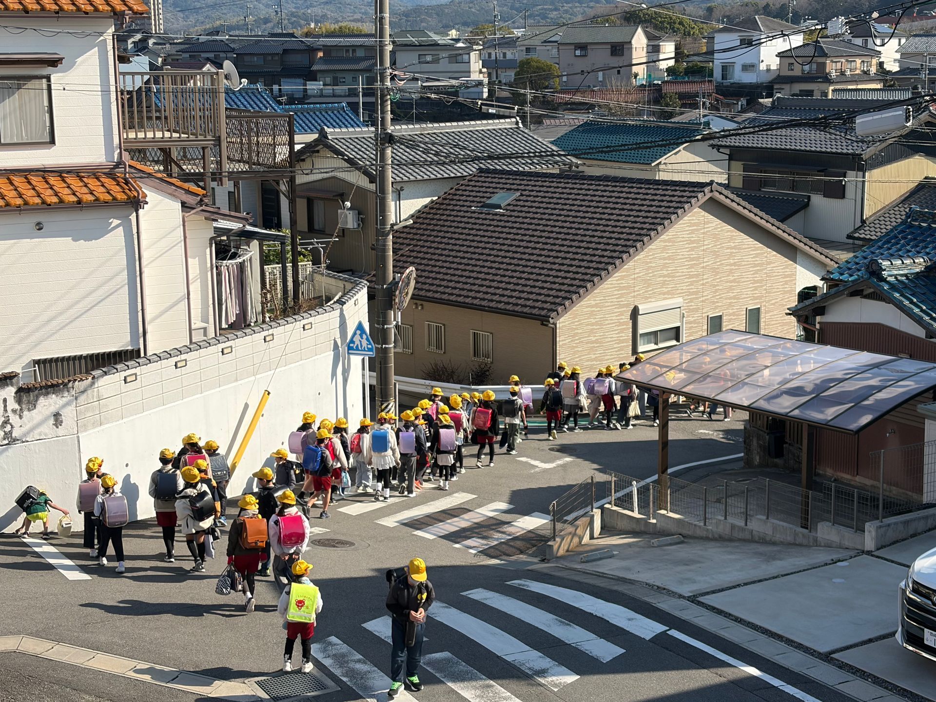 children with yellow caps leaving school