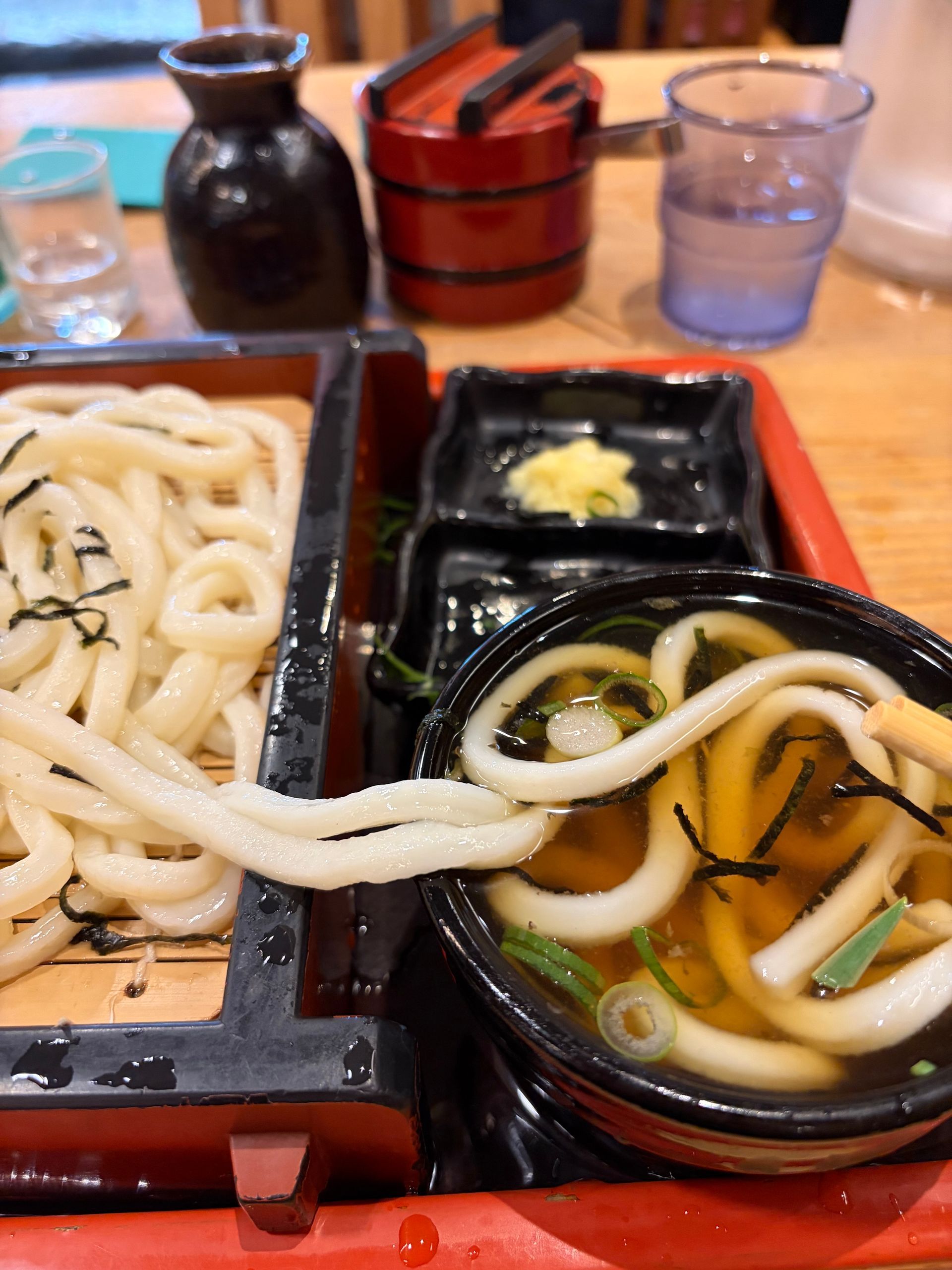you slide the chewe noodles in the cold broth with bits of spring onion