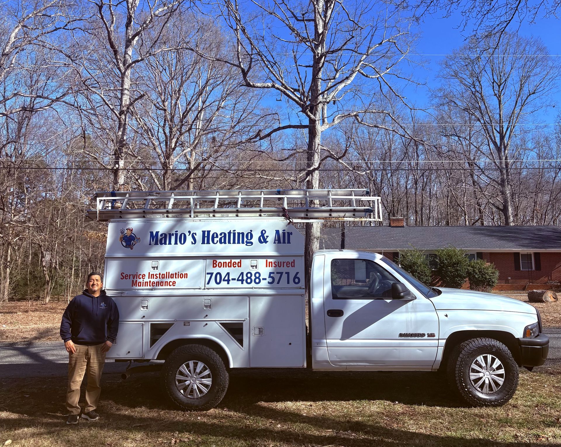 Man beside white work truck with