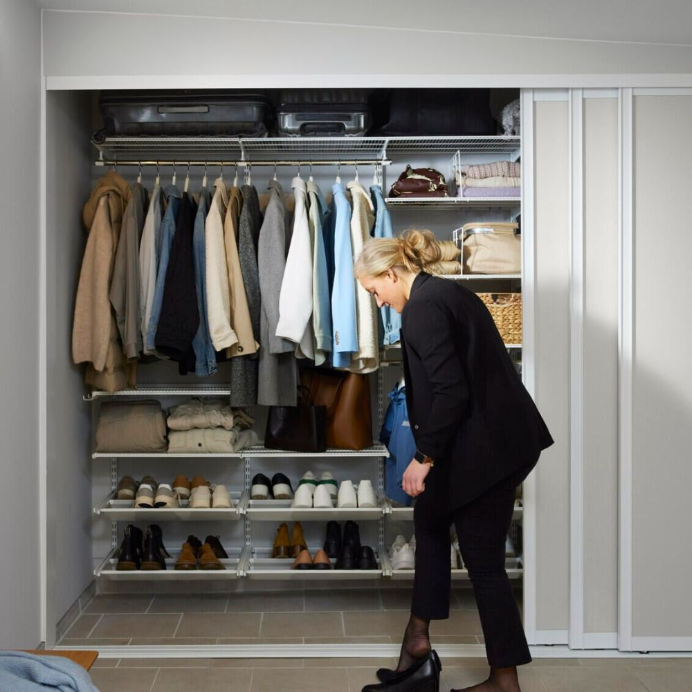 A woman in a black suit is standing in a closet  — Roll Edge In Manunda, QLD