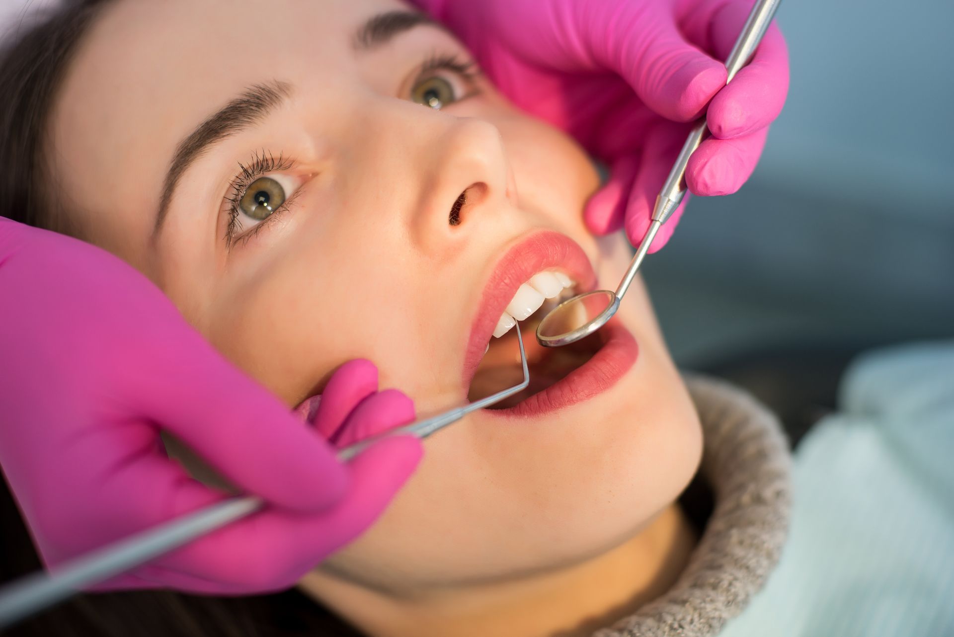 Person getting her teeth checked. Person getting her teeth checked.