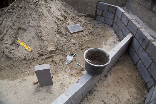 a bucket sitting on top of a pile of dirt