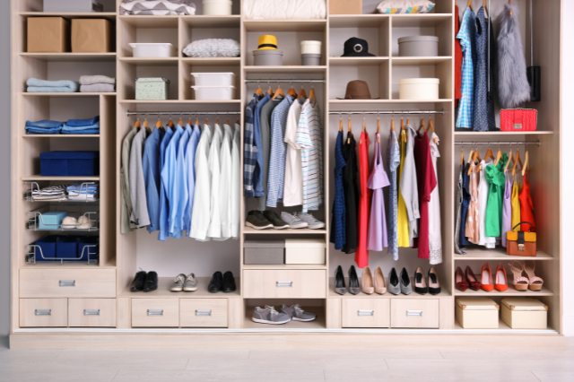 A fitted wardrobe filled with neatly organized clothes.