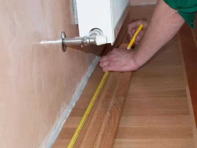 Derbyshire Joinery Specialists fitting a skirting board in Derby