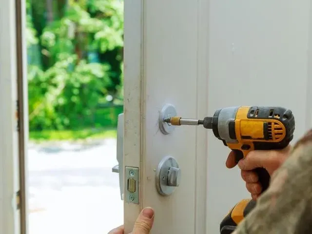 Derbyshire Joinery Specialists fitting a lock to a new door in Derby