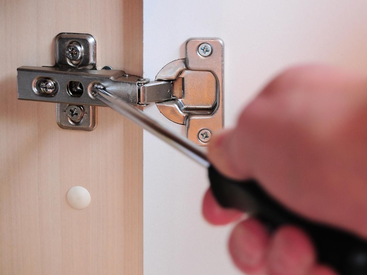 Derbyshire Joinery Specialists fitting a kitchen door to a cabinet for a new kitchen in Heanor