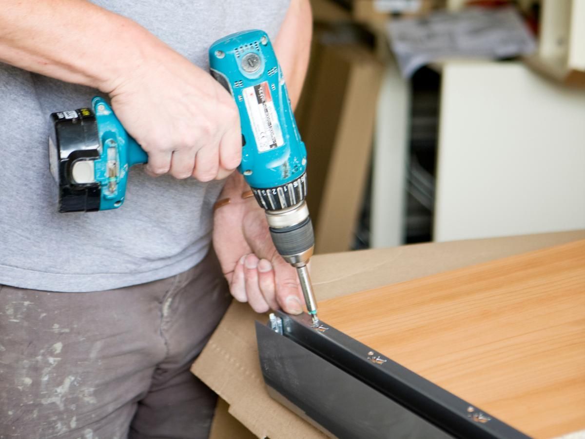 Derbyshire Joinery Specialists fitting a rail to a kitchen draw unit in Melbourne