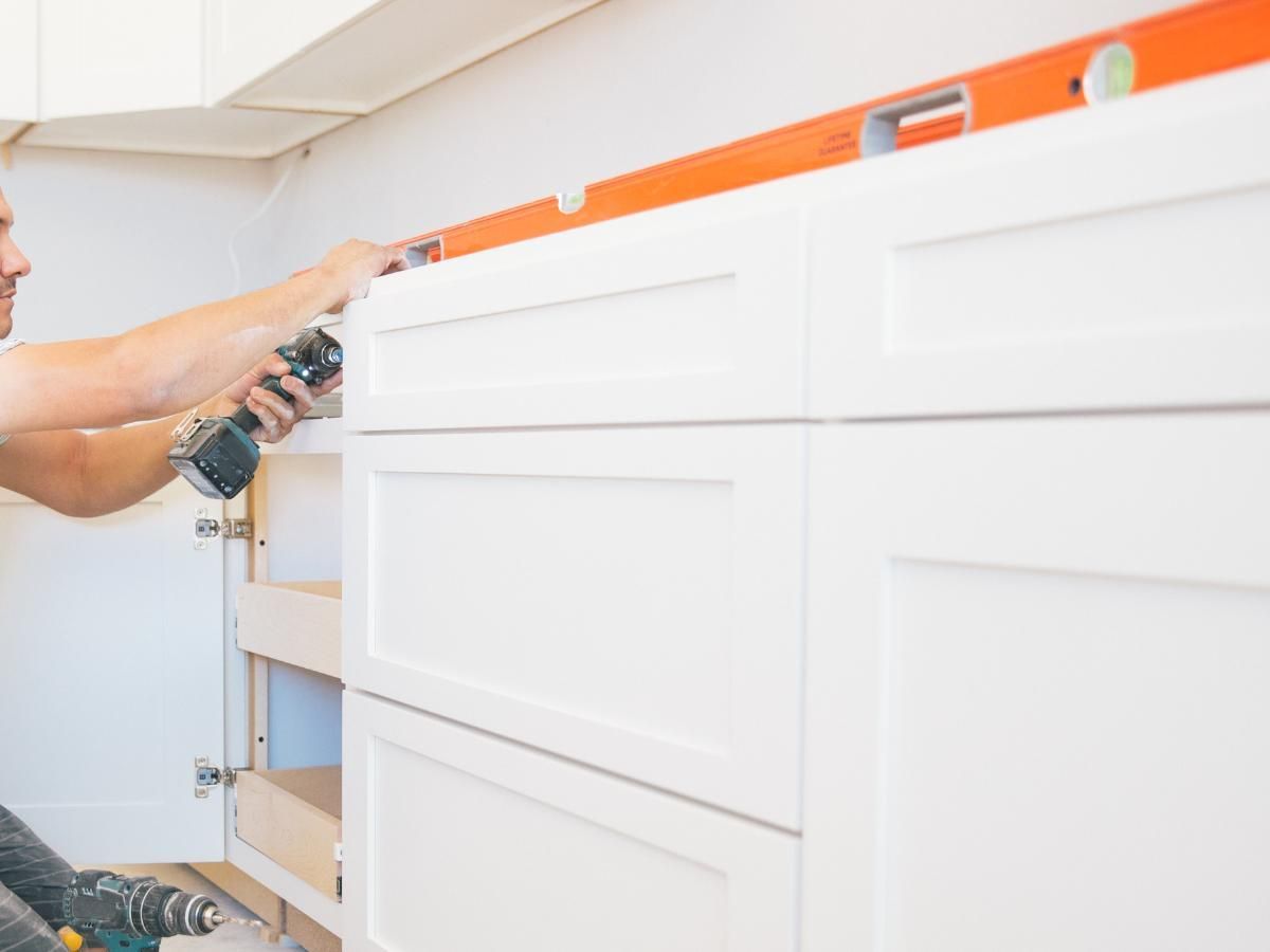 Derbyshire Joinery Specialists levelling a kitchen set of draws