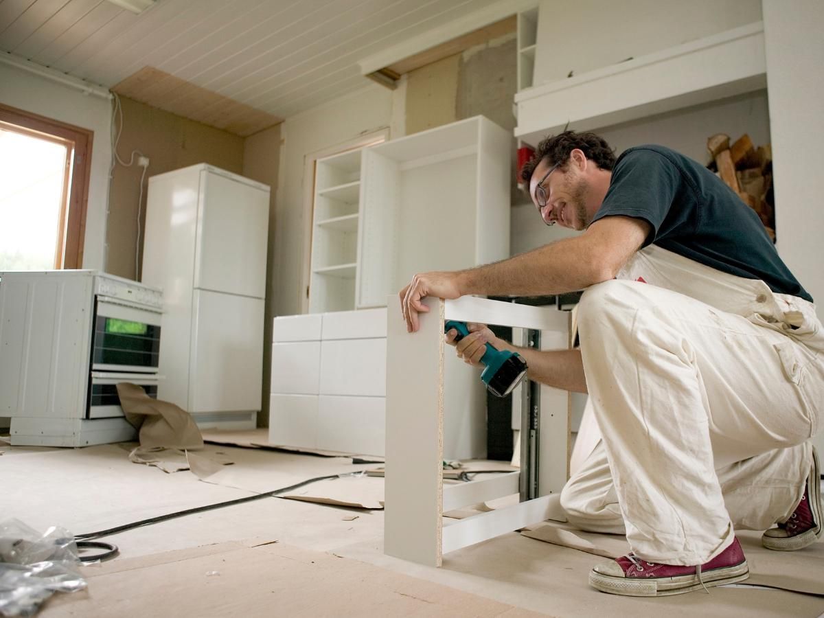 Derbyshire Joinery Specialists levelling a kitchen set of draws in Quarndon