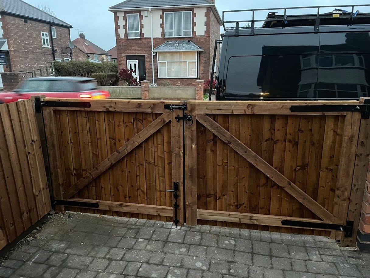 White painted wooden double driveway gates