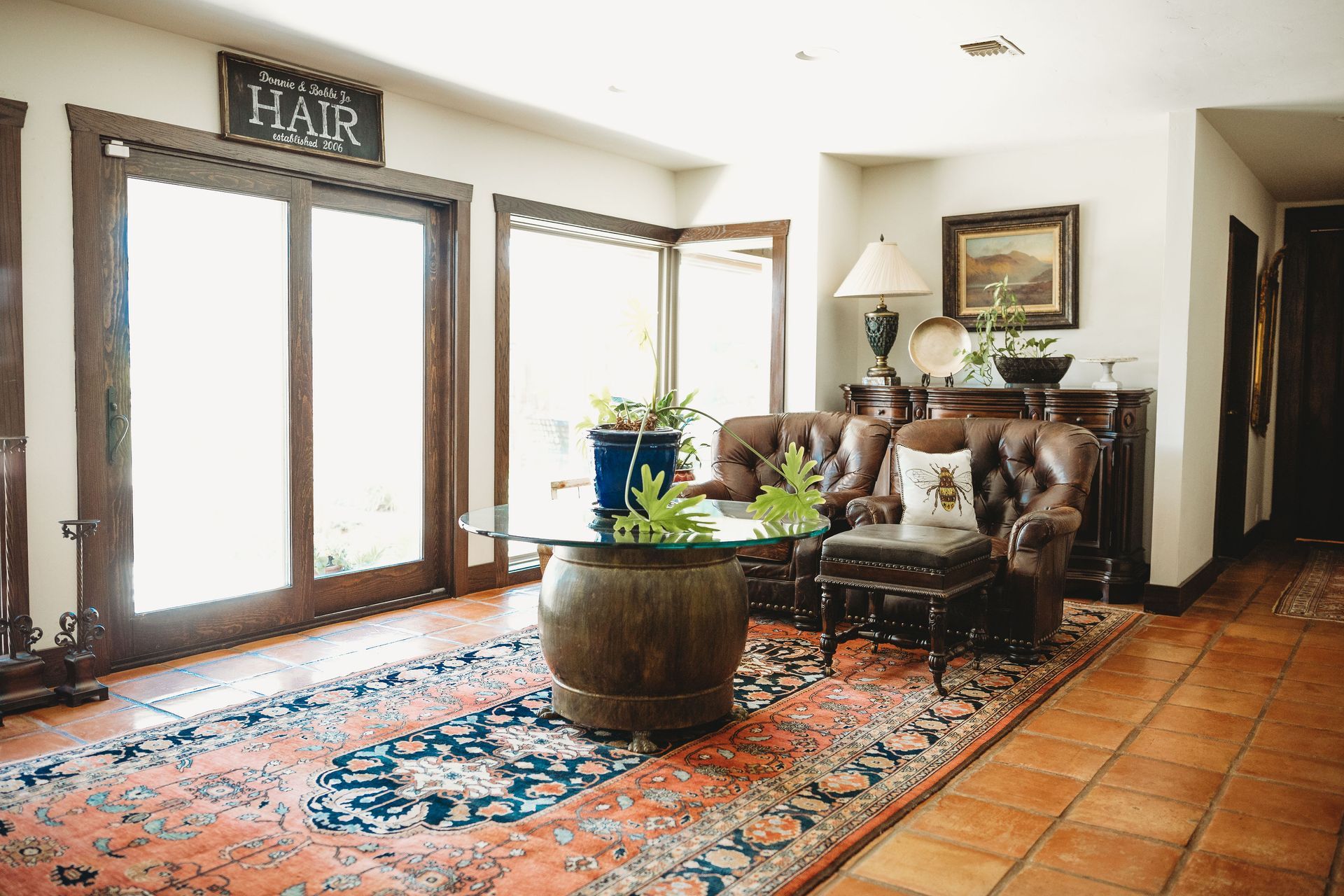 A living room with a couch , chair , table and rug.