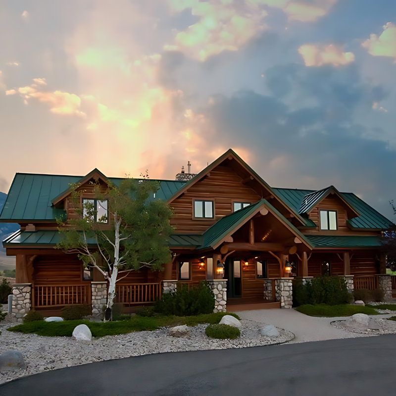 A large log cabin with a green roof