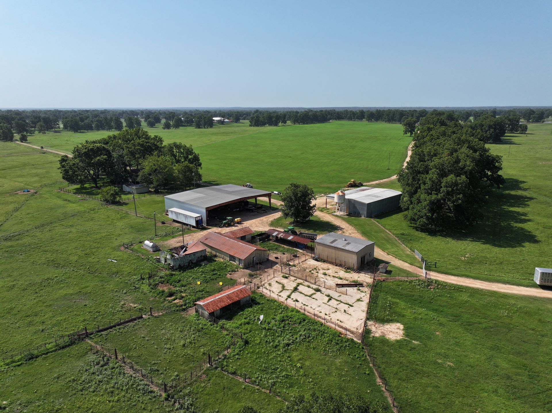 An aerial view of a farm with a lot of grass and buildings.