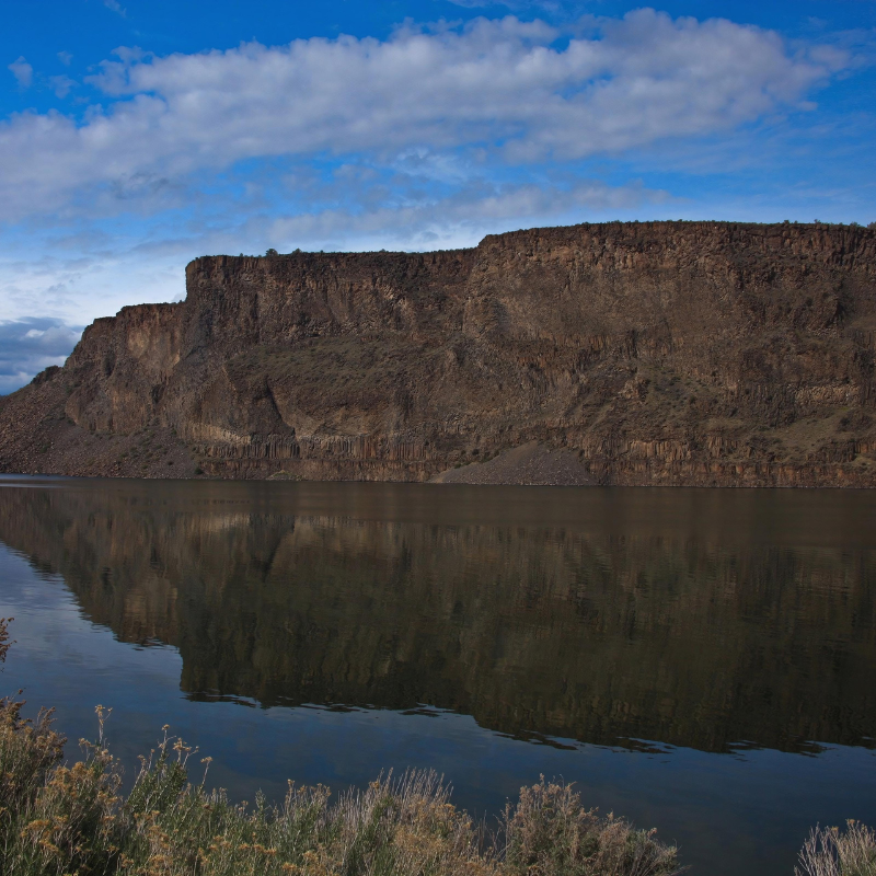 A large body of water with a mountain in the background
