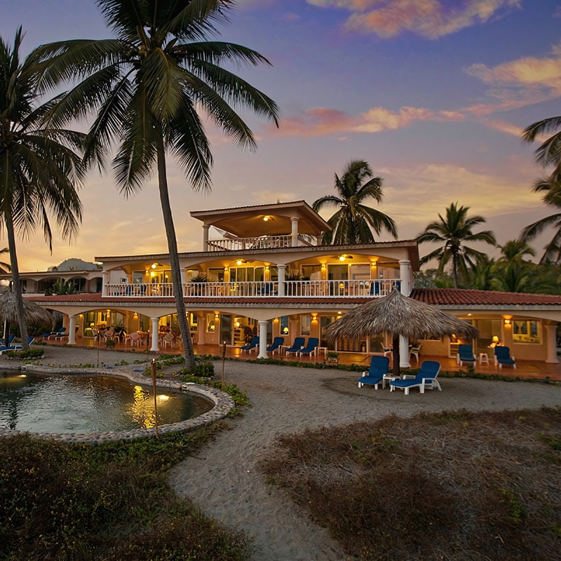 A large house with palm trees in front of it