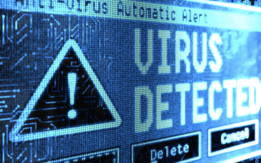 Picture of a computer screen. The computer screen is displaying a blue detected virus symbol.