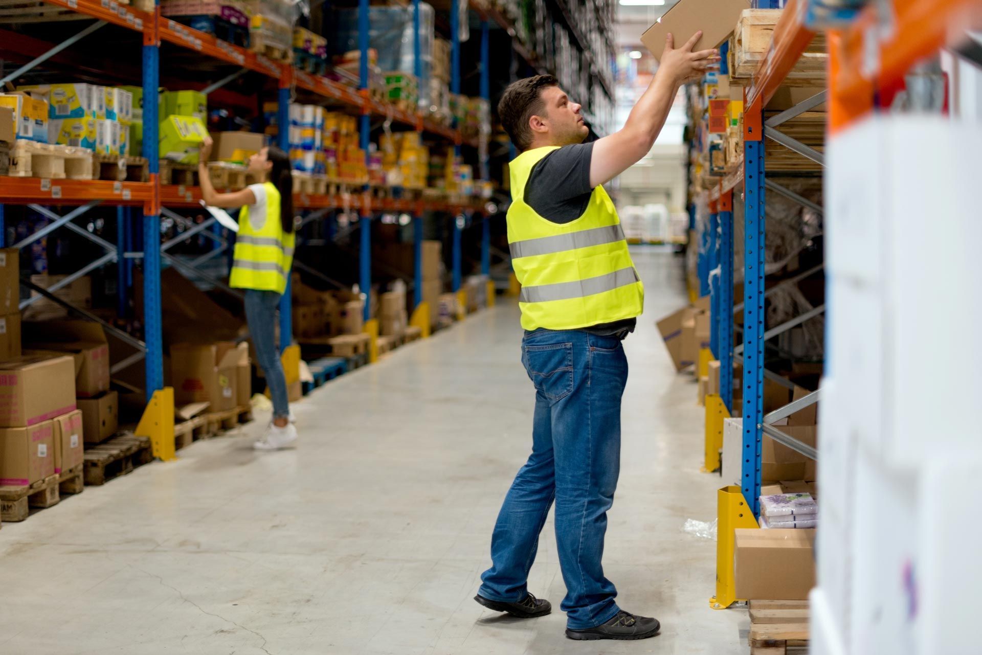 Commercial warehousing facility with employees managing stock and warehouse logistics tasks.