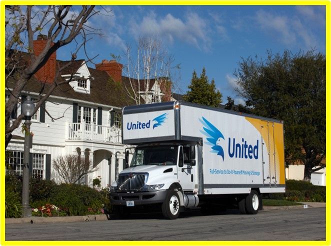 A united moving truck is parked in front of a house