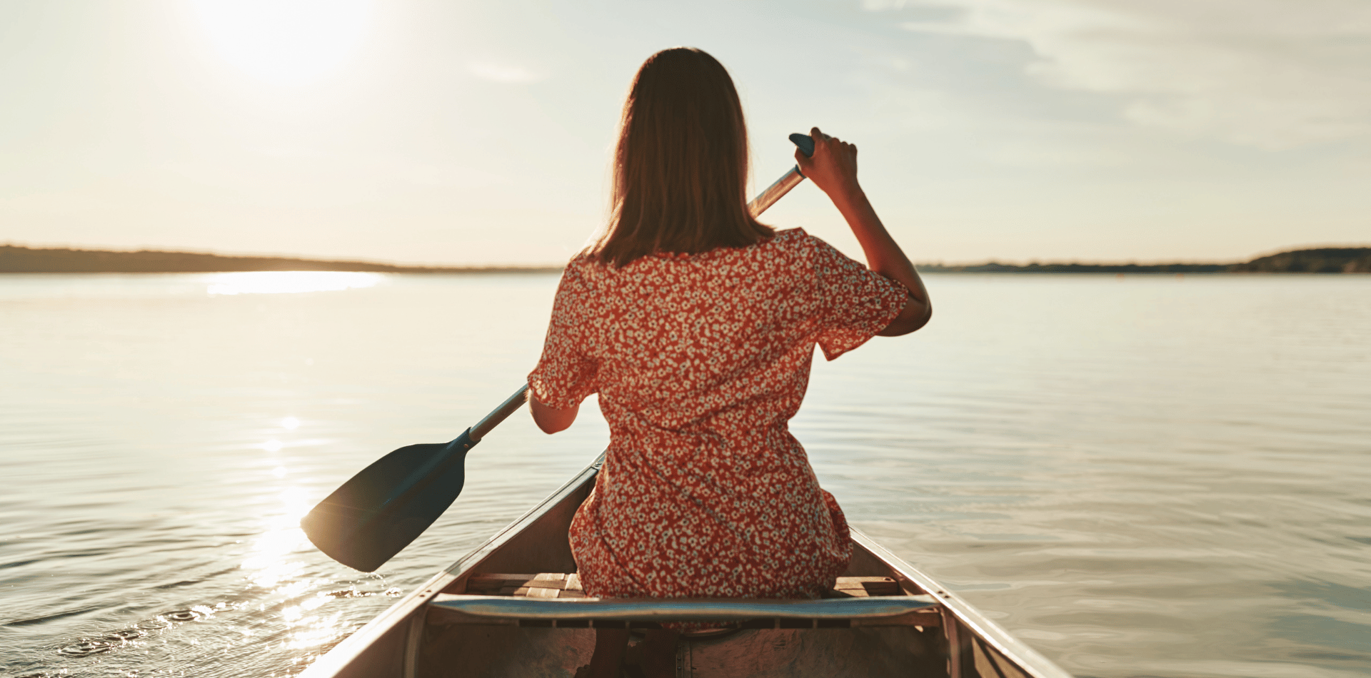 Woman paddling in a canoe
