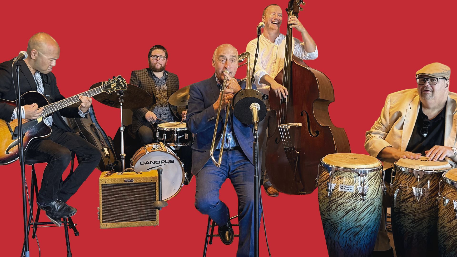 The Spangler/Paxton Band, a jazz ensemble, performs on stage in a dimly lit, sepia-toned setting.