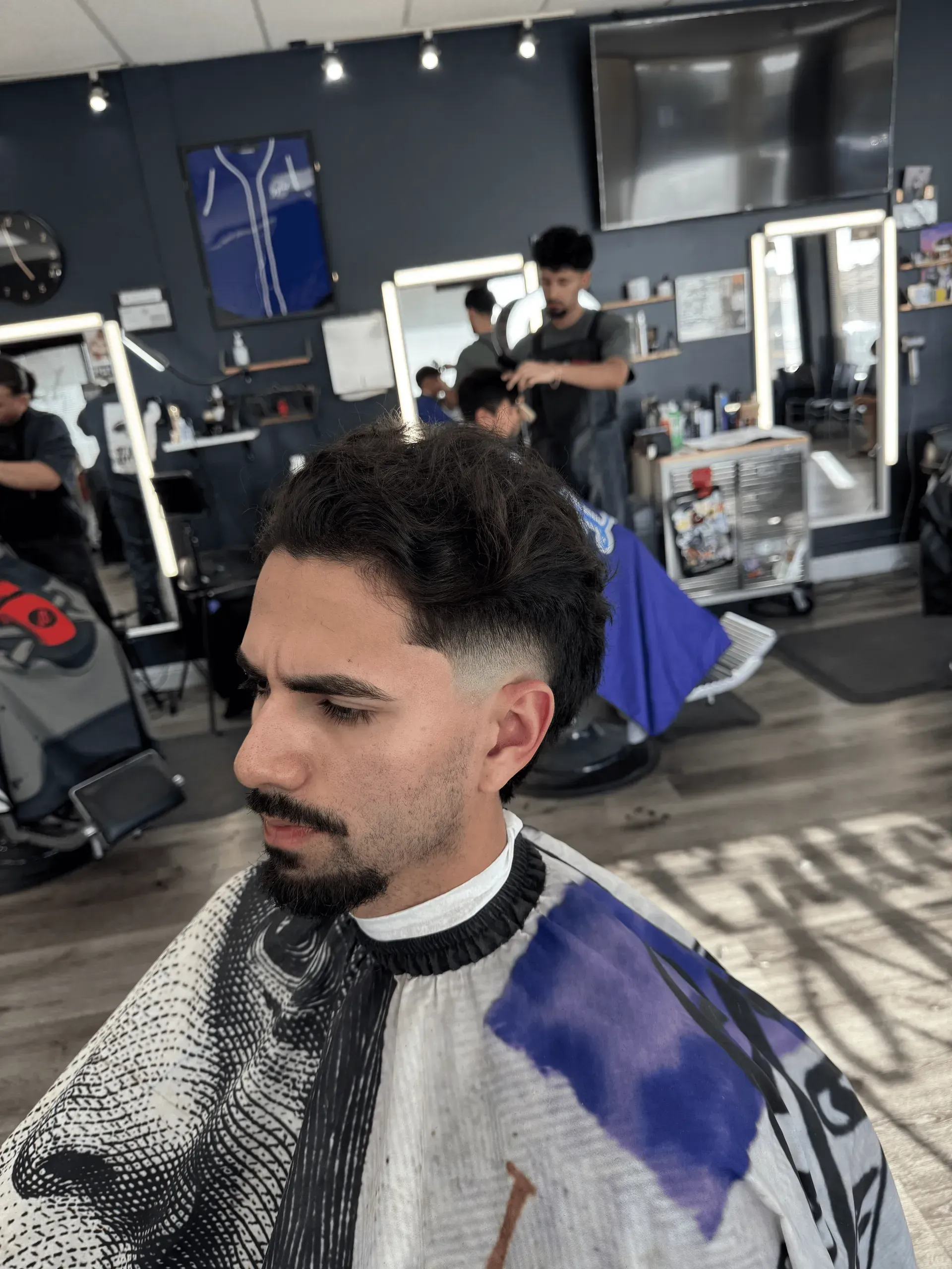 barber cutting men's hair with straight hair